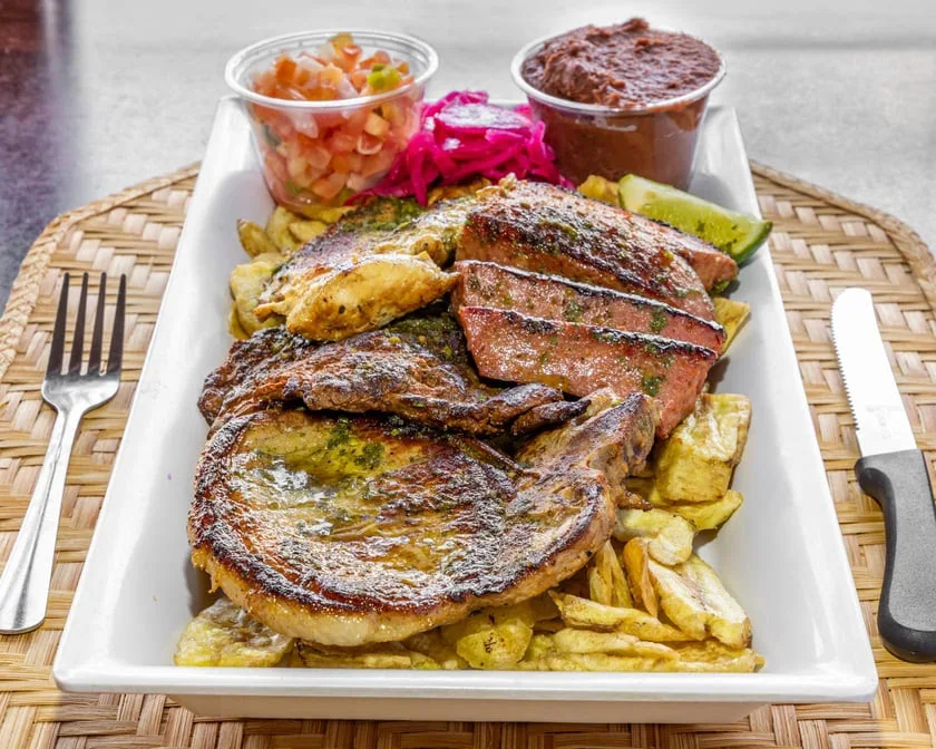 Parillada Mixta - A sizzling mixed grill platter featuring carne asada, chicken, chorizo, and more — perfect for sharing or a hearty solo feast.
